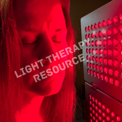 Person using a red light therapy device with 'Light Therapy Resources' text overlay.