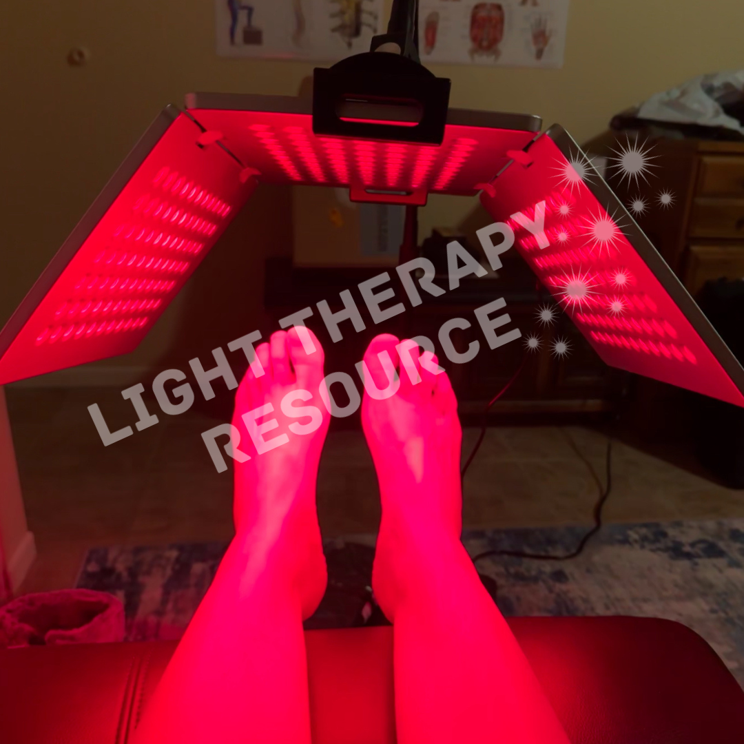 Person receiving red light therapy under a flip panel device labeled 'Light Therapy Resource'.