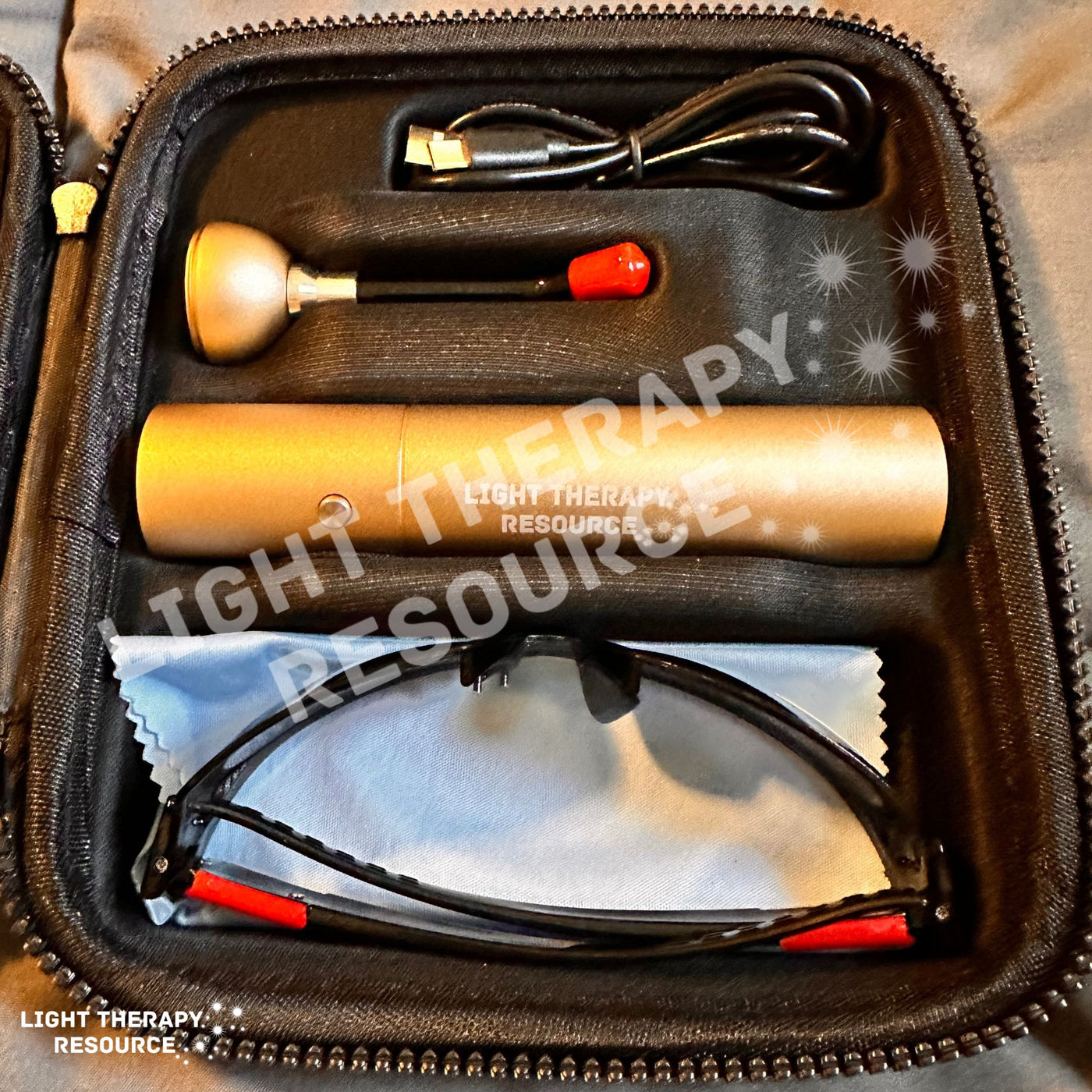 A gold colored red light therapy device with accessories in a carrying case with text oerlay 'Light Therapy Resource'.
