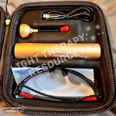 A gold colored red light therapy device with accessories in a carrying case with text oerlay 'Light Therapy Resource'.